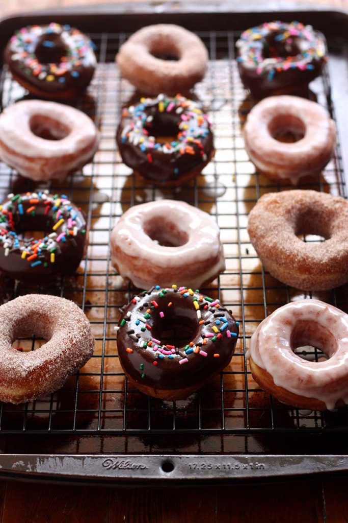 Yeast Doughnuts | Soft and fluffy yeast doughnuts three ways - with cinnamon-sugar, vanilla glaze, and chocolate with sprinkles. Find recipe at redstaryeast.com.