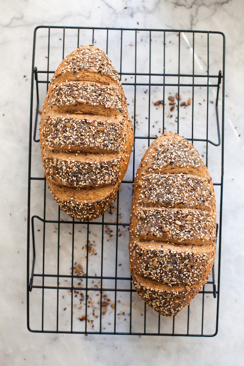 two loaves of bread on a wire rack