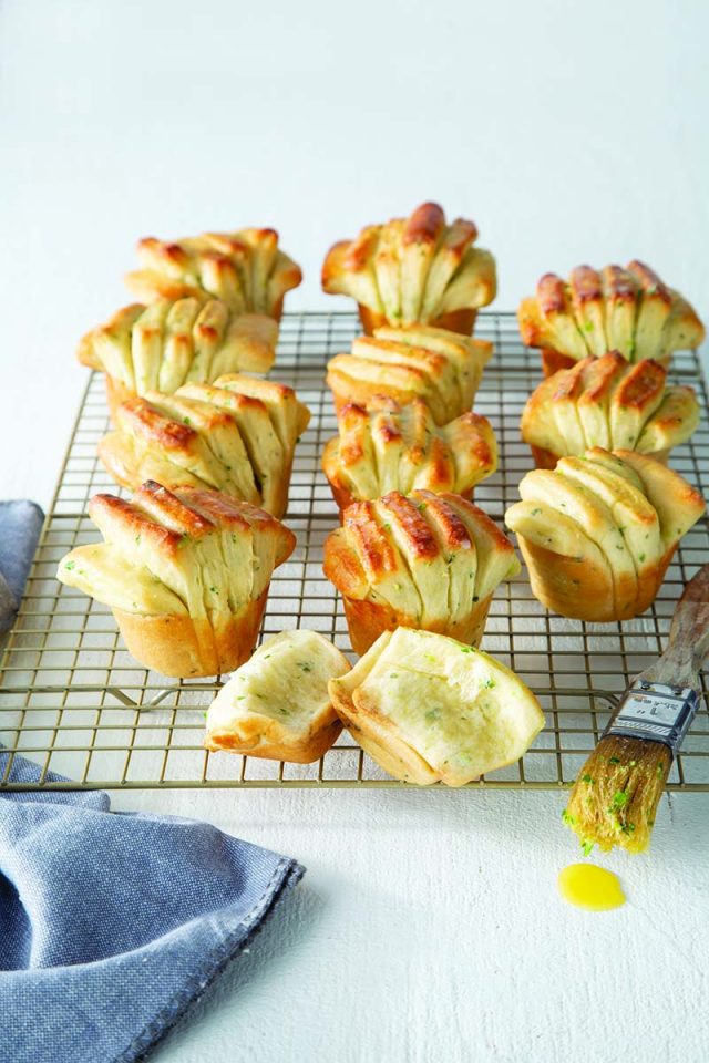 Sour Cream Fantail Dinner Rolls | A miniature pull-apart dream, these fantail dinner rolls pack tangy sour cream and bright green onion flavor in spades. Delicately tender, our base dough gets a fluffy boost from Platinum Yeast before being brushed with melted butter and sandwiched into its classic fantail shape. Get recipe at redstaryeast.com.